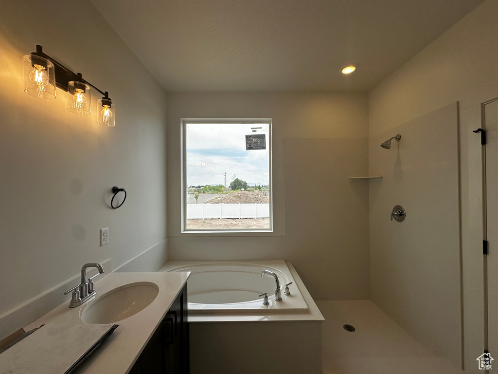 Full bath featuring a garden tub, vanity, a shower, and recessed lighting