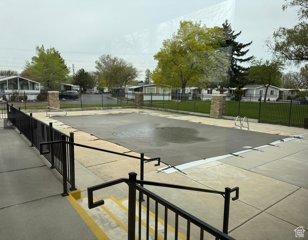 Community pool with a residential view