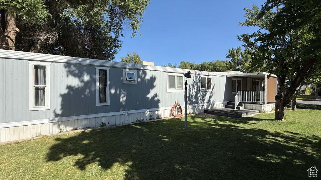 Back of house featuring a lawn
