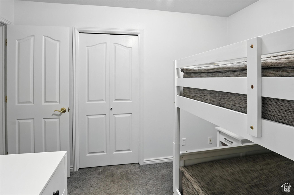Unfurnished bedroom featuring carpet floors and a closet
