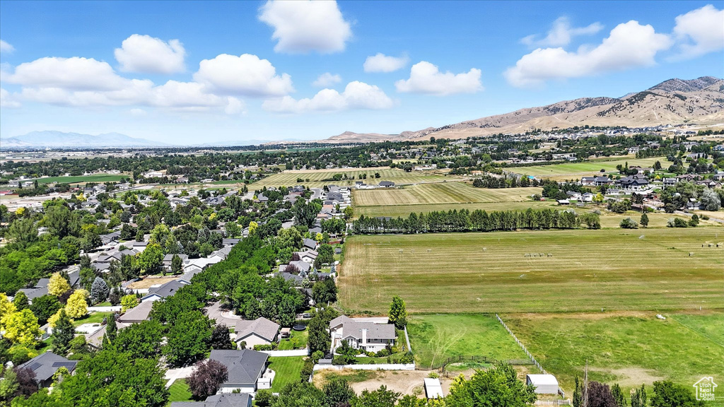 View of rural area with a mountain backdrop and large plots for crops