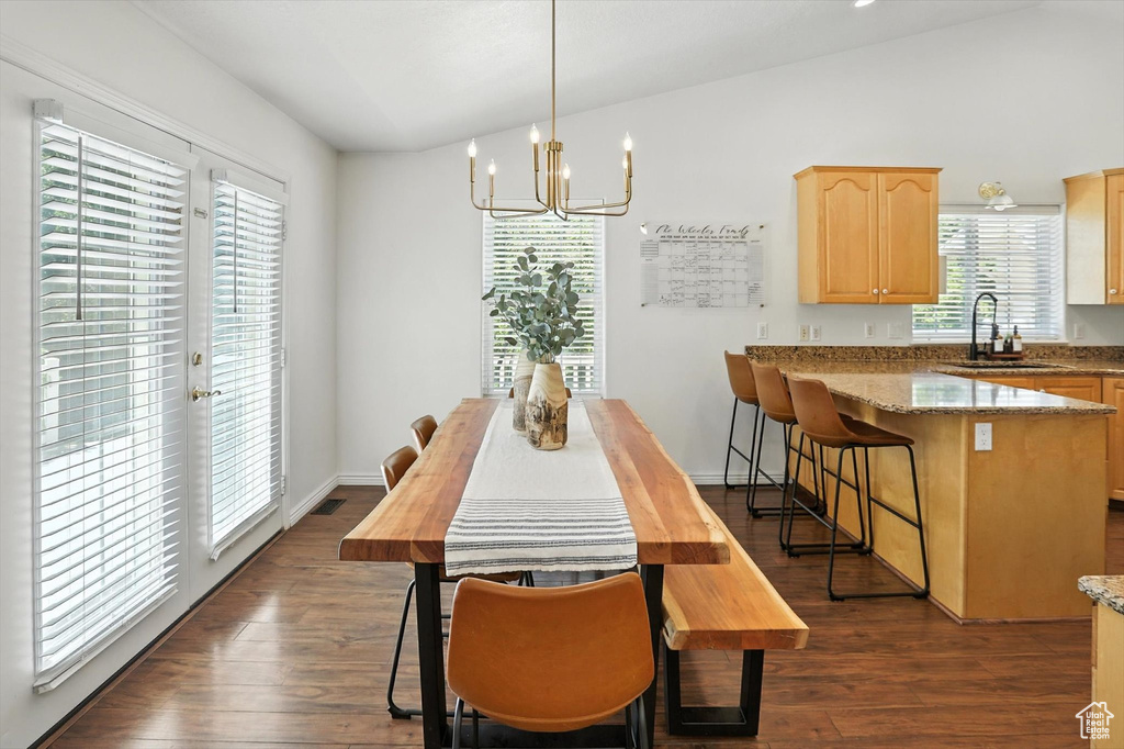 Dining area featuring a chandelier and dark wood finished floors