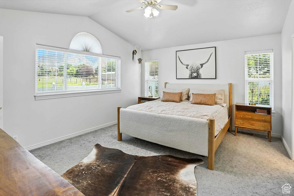 Bedroom featuring carpet floors, lofted ceiling, and ceiling fan