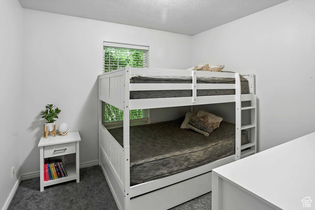 Bedroom with carpet and a textured ceiling