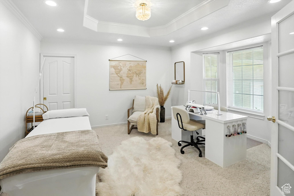 Carpeted office space featuring recessed lighting, ornamental molding, and a raised ceiling