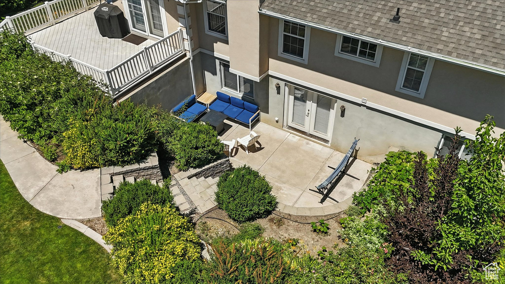 Back of property with roof with shingles, stucco siding, french doors, and a patio area