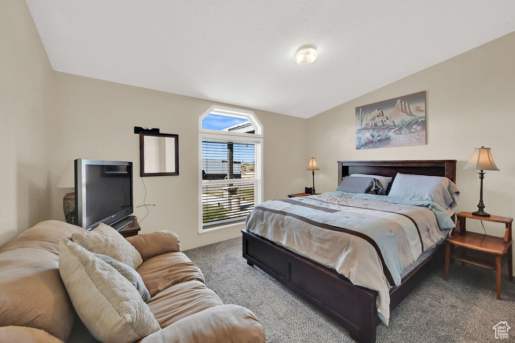 Bedroom with carpet and lofted ceiling