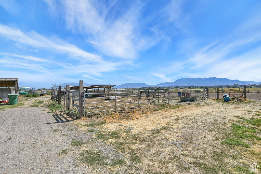 View of yard featuring a mountain view, a view of countryside, and an exterior structure