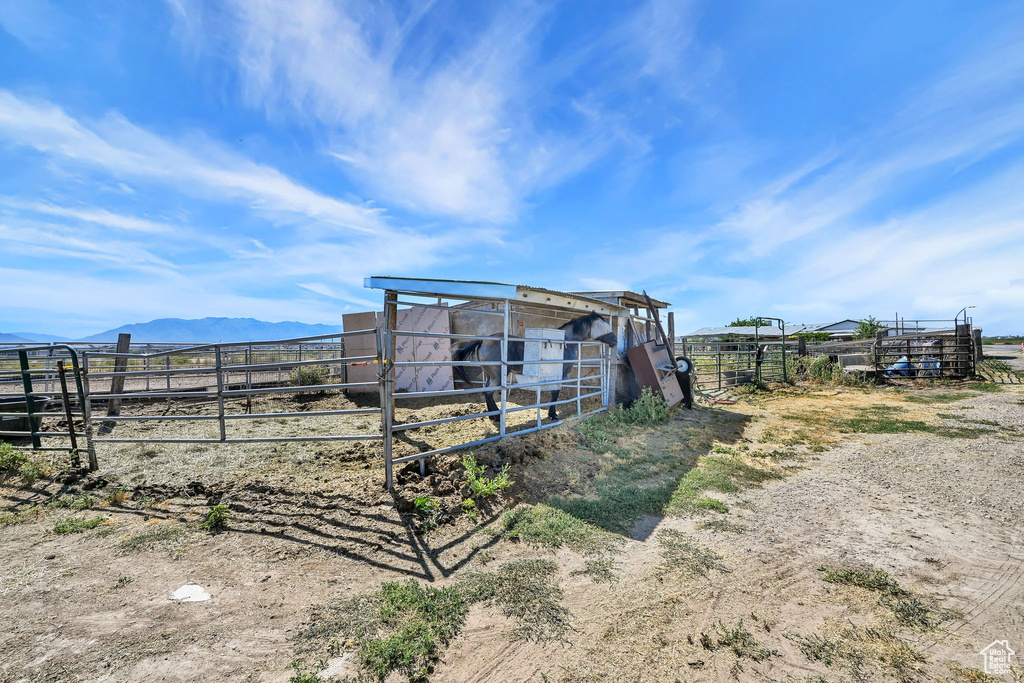 View of yard with an exterior structure, an outbuilding, a mountain view, and a view of rural / pastoral area