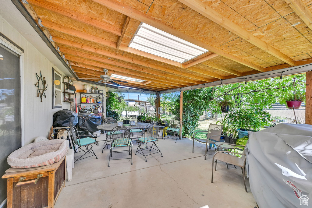 View of patio with outdoor dining space and ceiling fan
