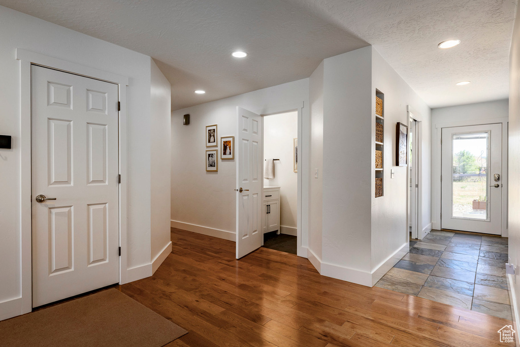 Entryway featuring wood finished floors, recessed lighting, and a textured ceiling
