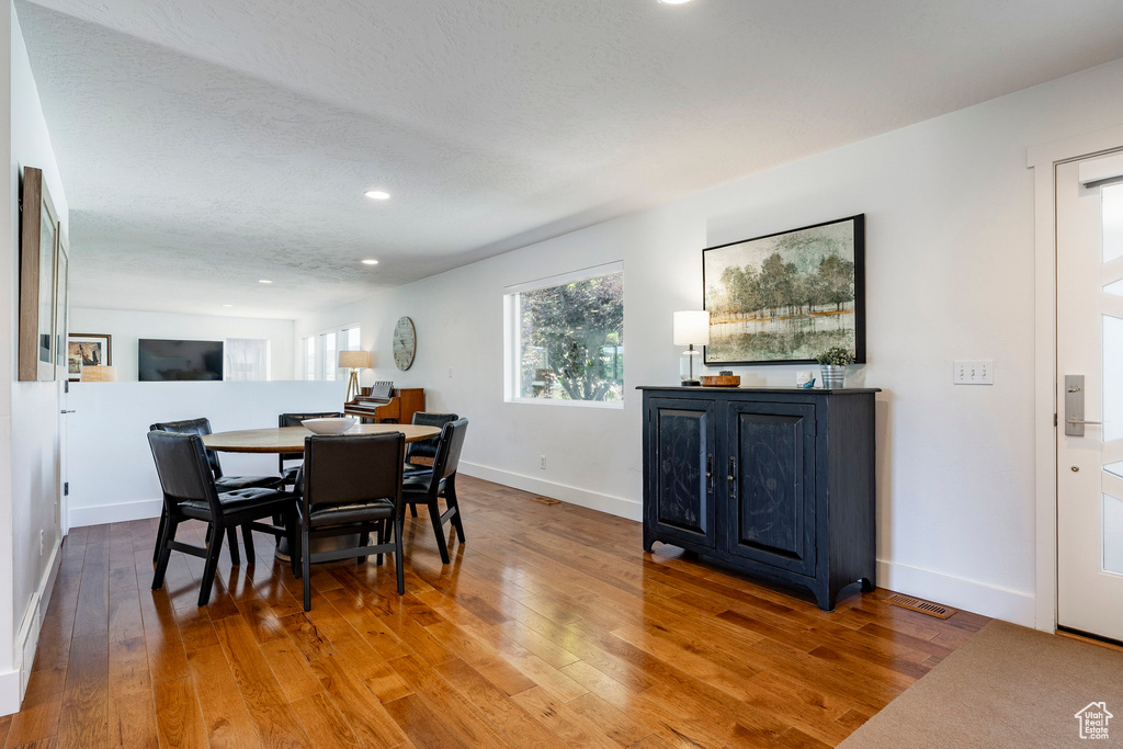 Dining room featuring wood finished floors and recessed lighting