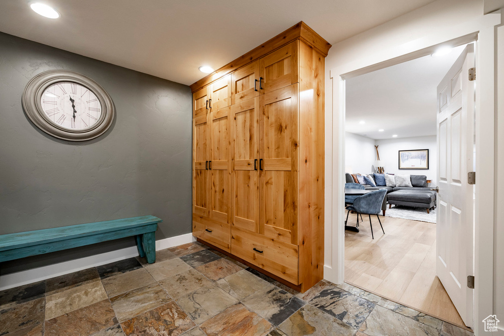Foyer entrance with stone tile floors and recessed lighting