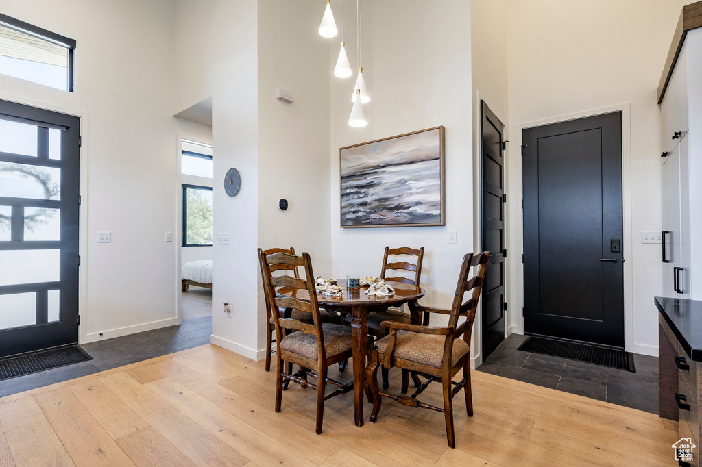 Entryway with a towering ceiling and hardwood / wood-style flooring