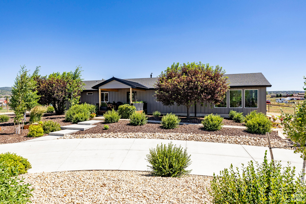 Single story home featuring roof with shingles