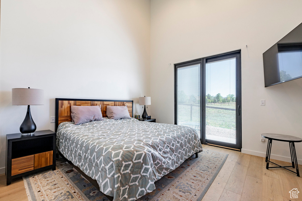 Bedroom featuring access to outside and light wood-style flooring