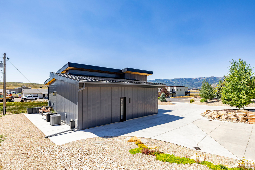View of home's exterior featuring a mountain view, a patio area, and a metal roof