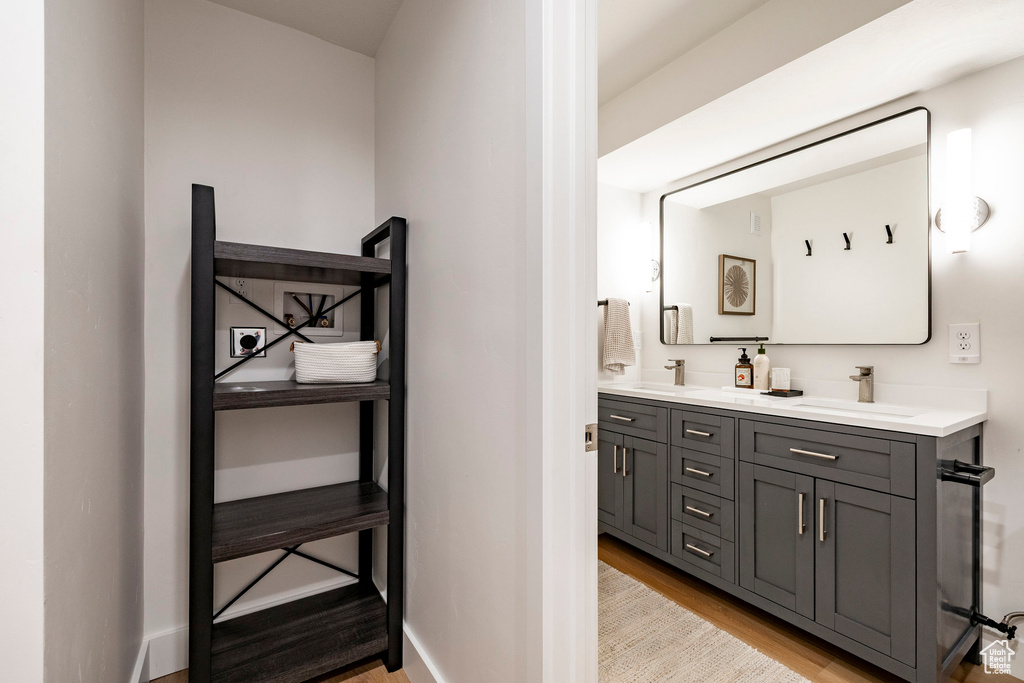 Bathroom featuring wood finished floors and double vanity