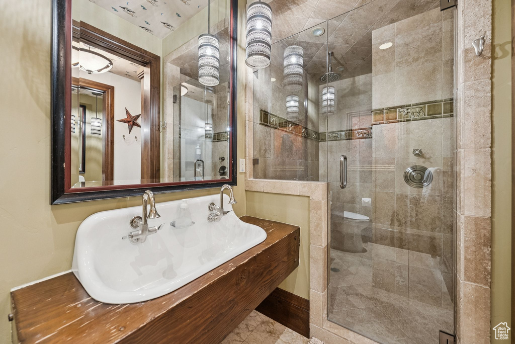 Bathroom with a sink and a stall shower