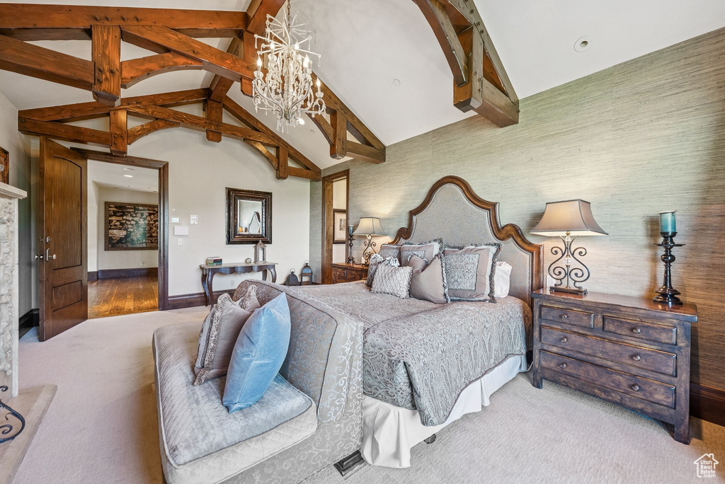 Carpeted bedroom featuring beam ceiling, a chandelier, and high vaulted ceiling
