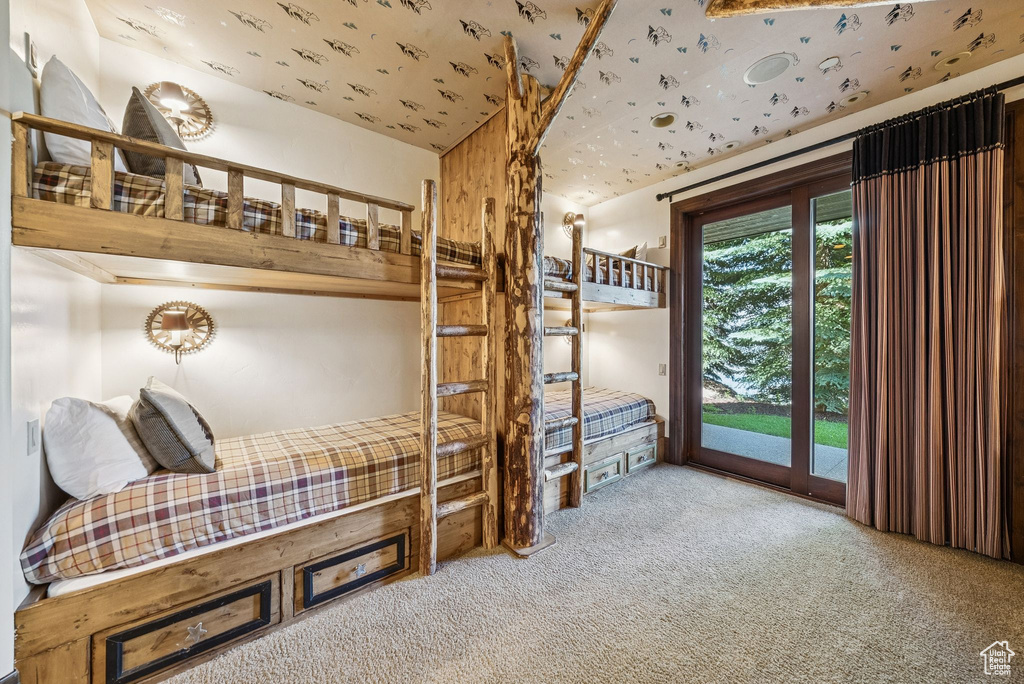 Carpeted bedroom with access to exterior