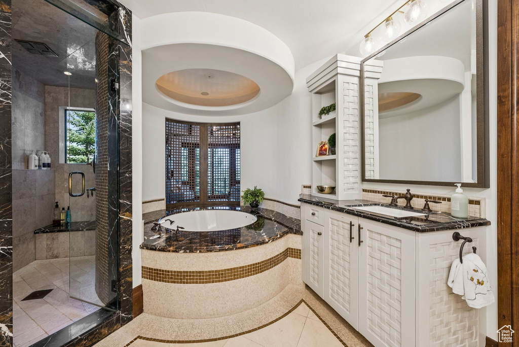 Full bath featuring a bath, a shower stall, vanity, and tile patterned flooring