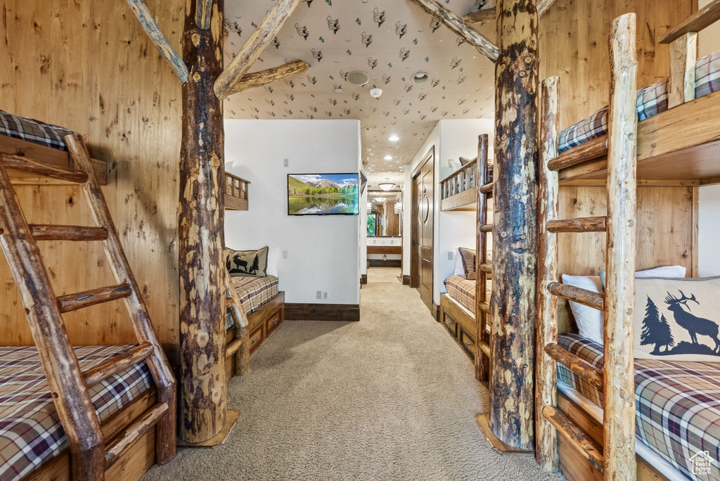 Hall with carpet and wood walls