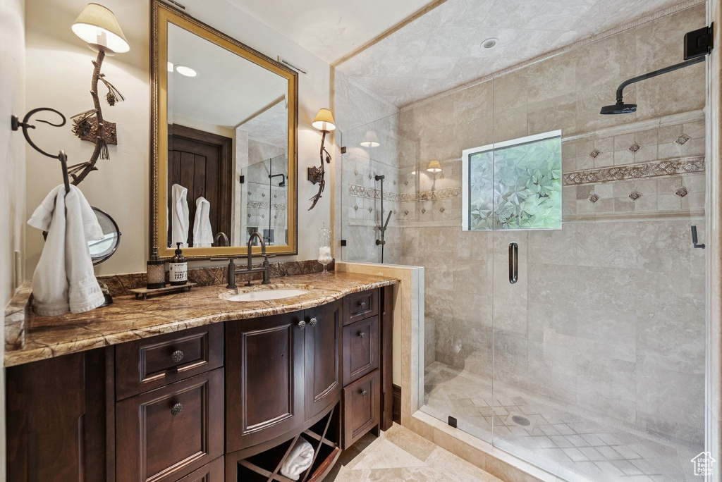 Bathroom with vanity and a stall shower