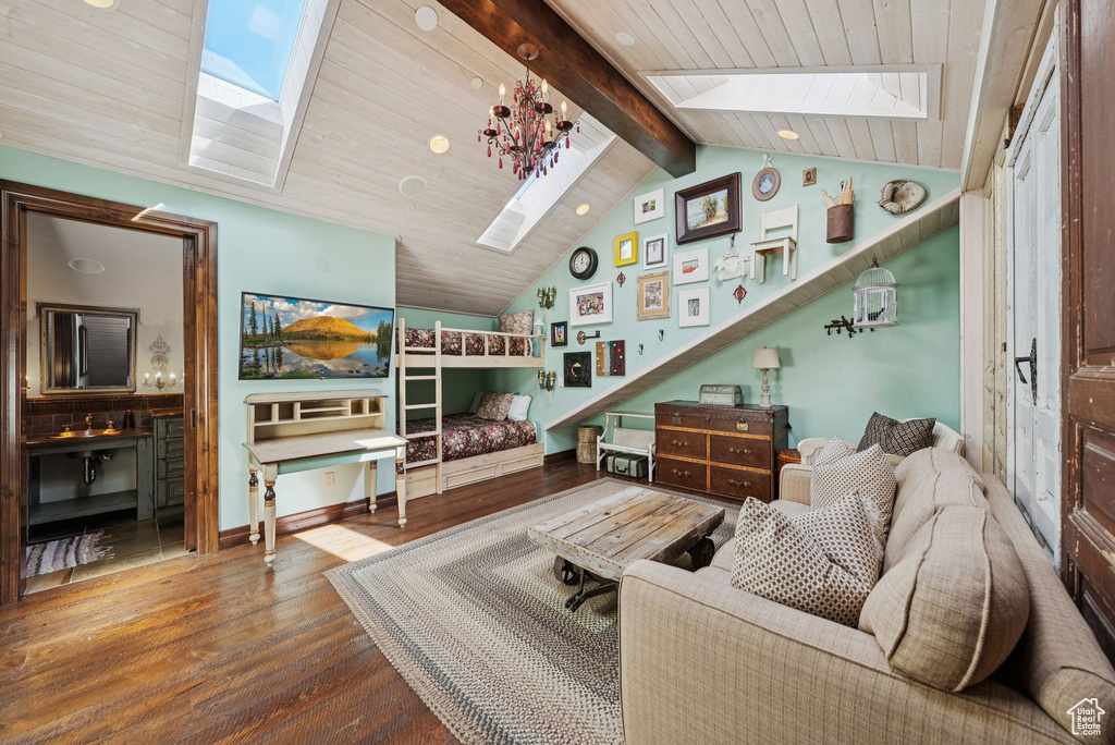 Living room with a skylight, wood finished floors, and wooden ceiling