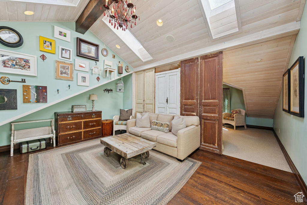 Living area with dark wood-type flooring, wooden ceiling, and a chandelier
