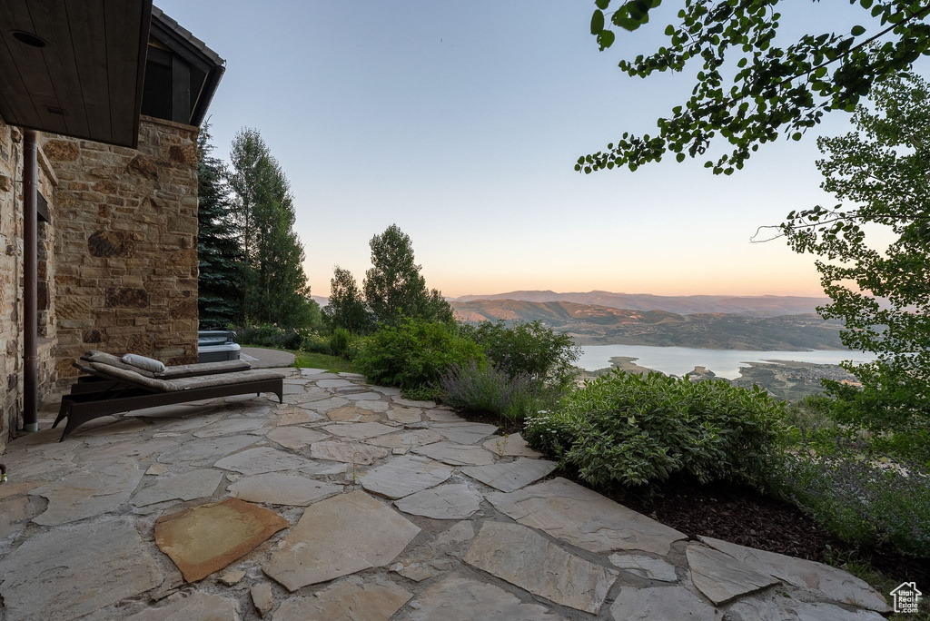 View of patio / terrace featuring a water and mountain view