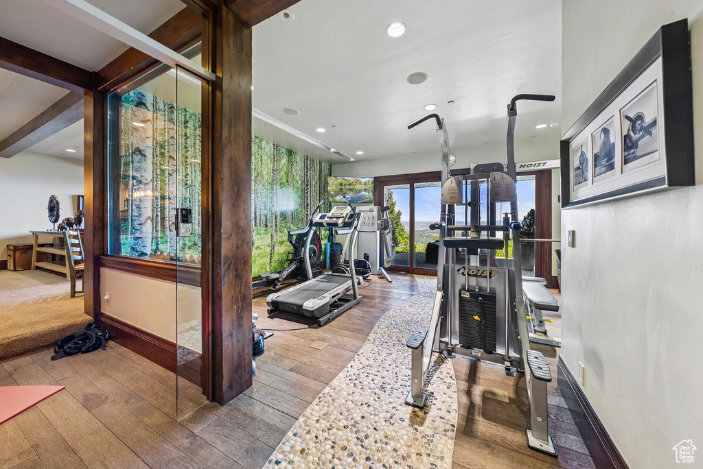Gym with hardwood / wood-style floors and recessed lighting