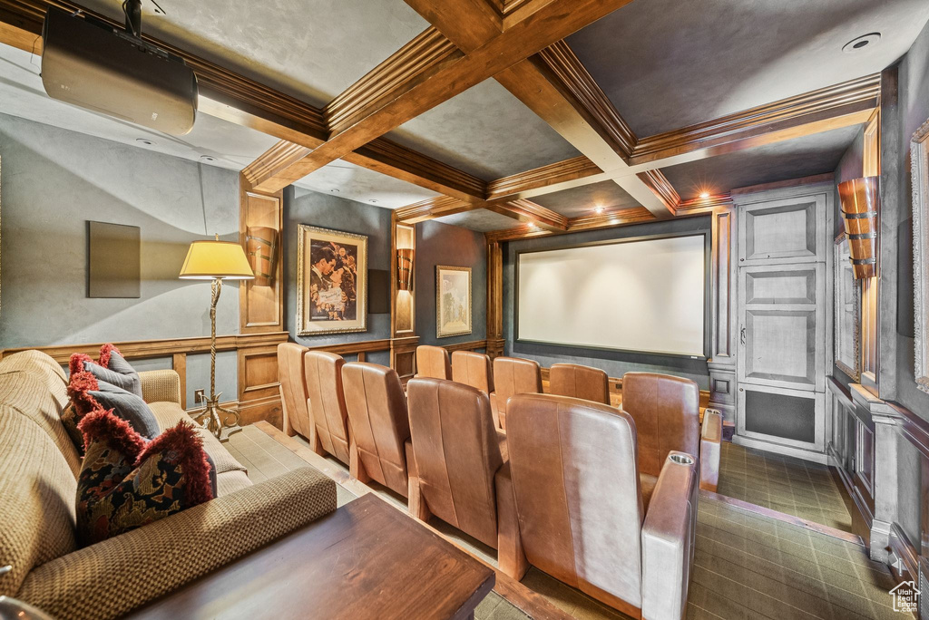 Cinema room featuring a decorative wall, coffered ceiling, beamed ceiling, and crown molding