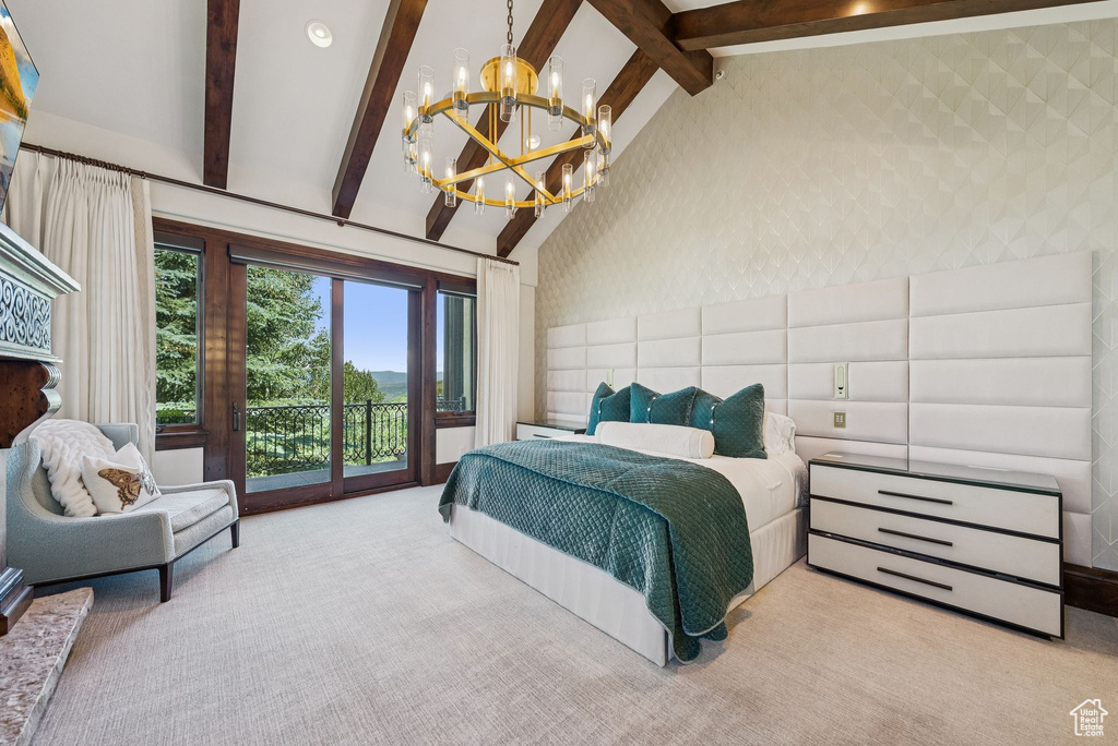 Carpeted bedroom featuring access to outside and a chandelier