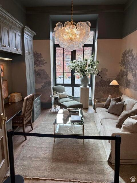 Living room with a chandelier and light wood-type flooring