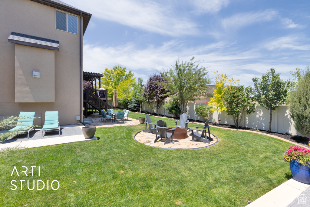 Fenced backyard with an outdoor fire pit, a patio area, and a pergola