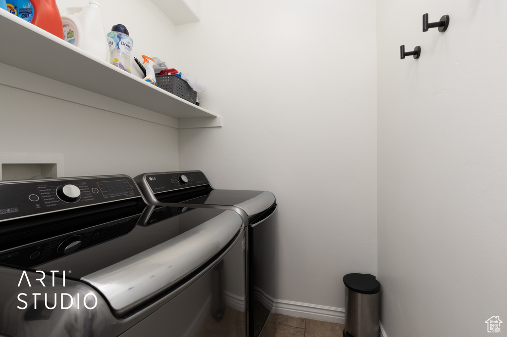 Laundry room featuring washer and dryer and baseboards