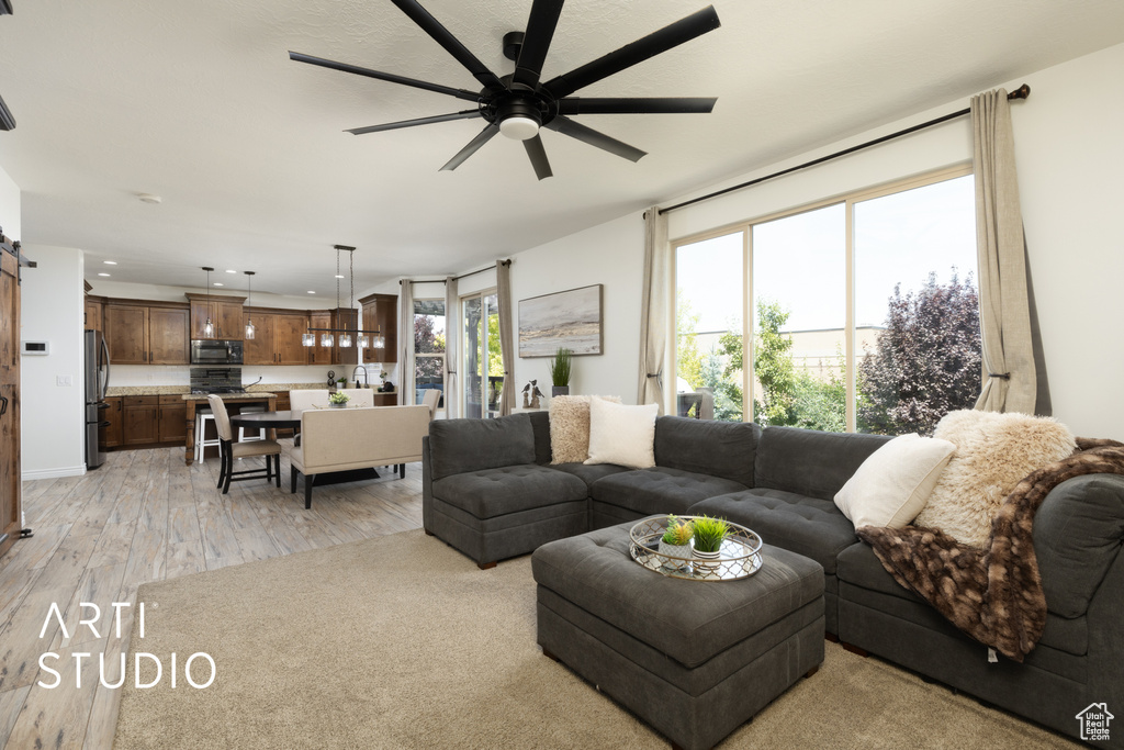 Living room featuring ceiling fan, light wood-style floors, and recessed lighting