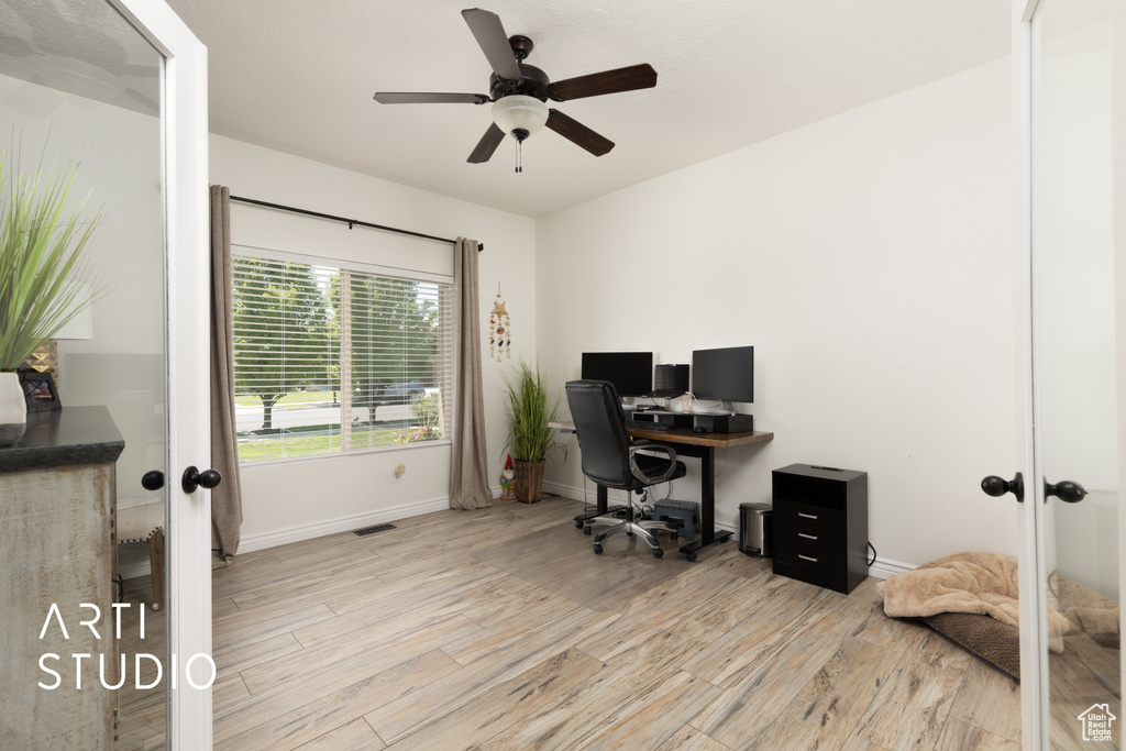 Office area with french doors, ceiling fan, and wood finished floors
