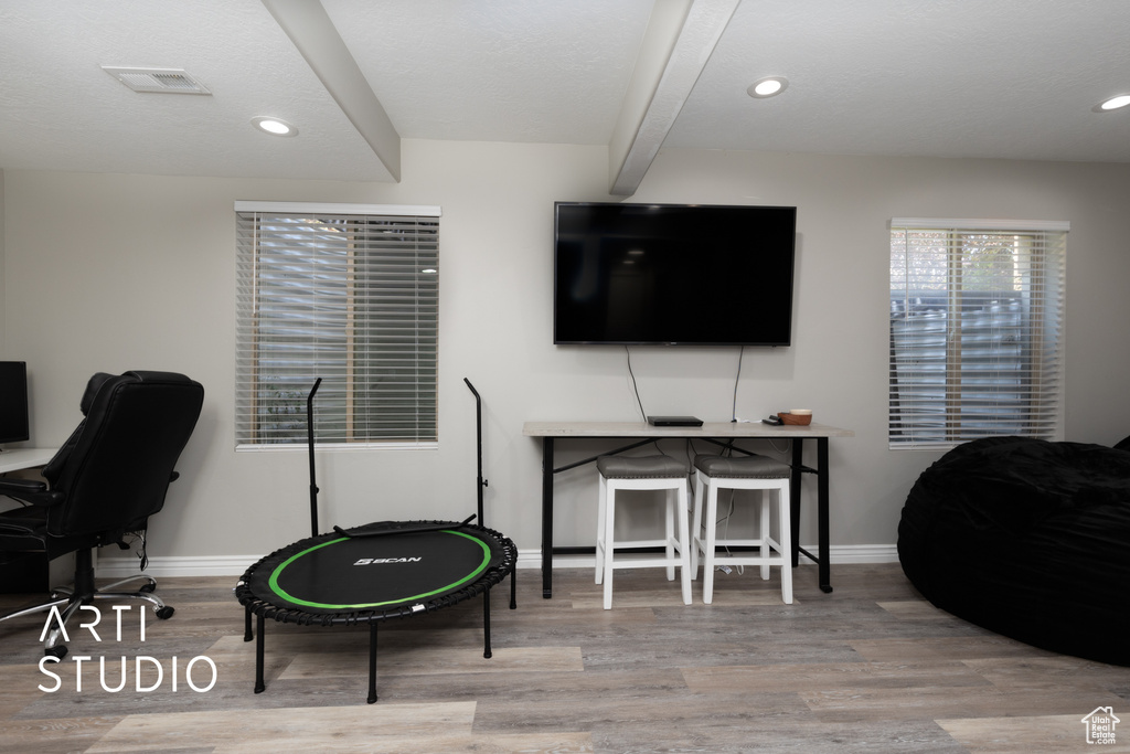 Office with wood finished floors, recessed lighting, and beam ceiling