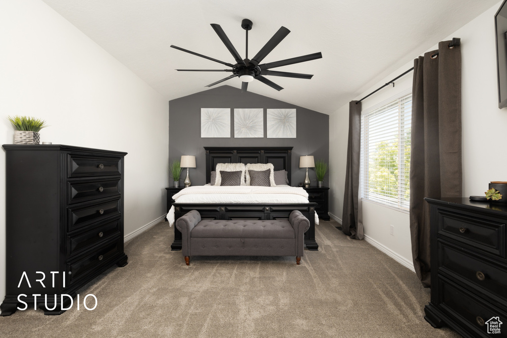 Bedroom featuring light carpet, vaulted ceiling, and a ceiling fan