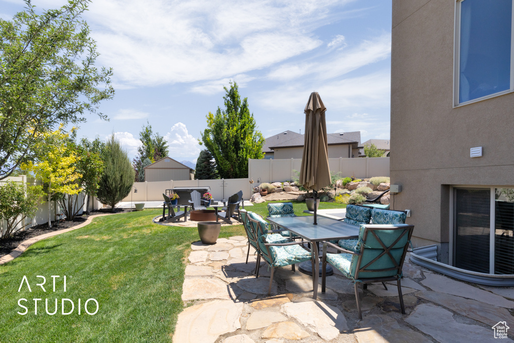 Fenced backyard featuring a patio area and outdoor dining area