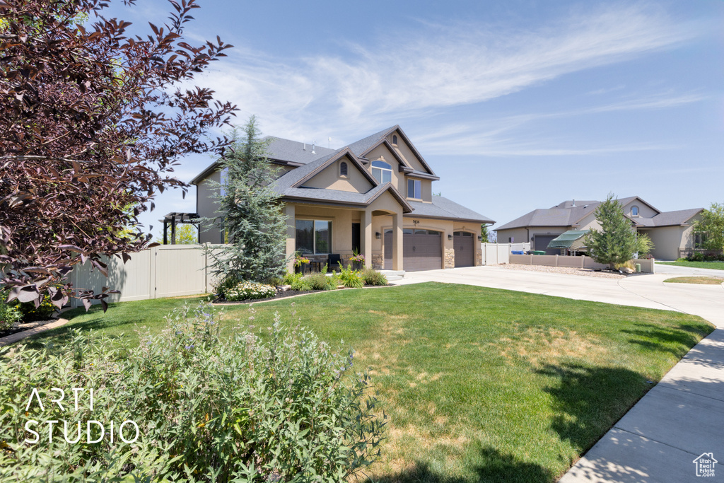 View of front facade featuring stucco siding, concrete driveway, and an attached garage