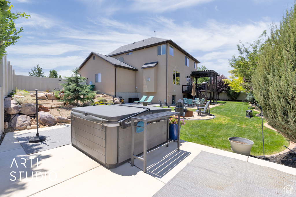 Fenced backyard featuring a hot tub, a patio, and a pergola