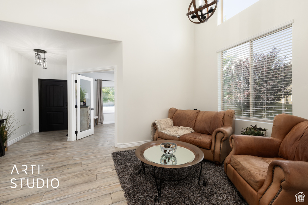 Living area featuring light wood finished floors and a chandelier