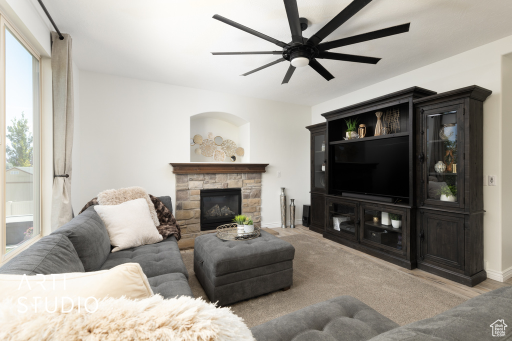 Living area with a ceiling fan and a fireplace