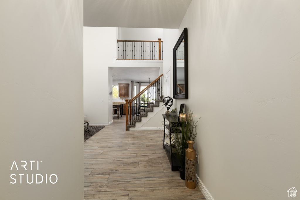 Corridor with stairway and wood finished floors