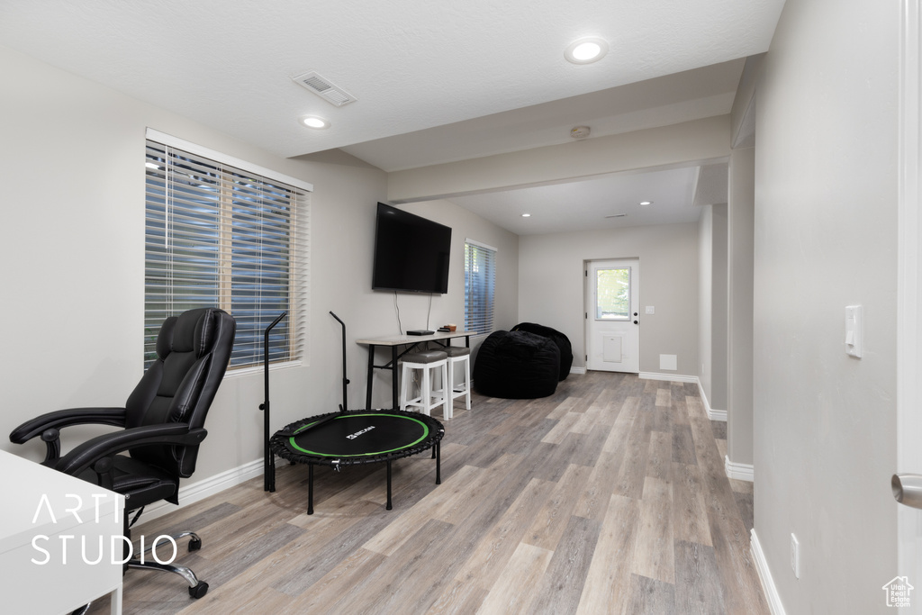 Home office featuring light wood-style floors and recessed lighting