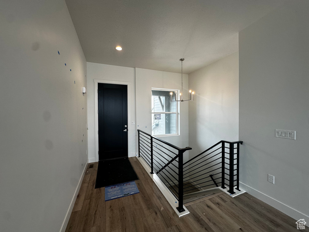 Foyer entrance featuring wood finished floors, a chandelier, and recessed lighting