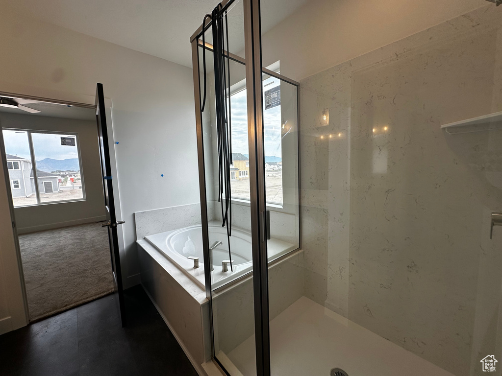 Bathroom featuring a bath and a stall shower